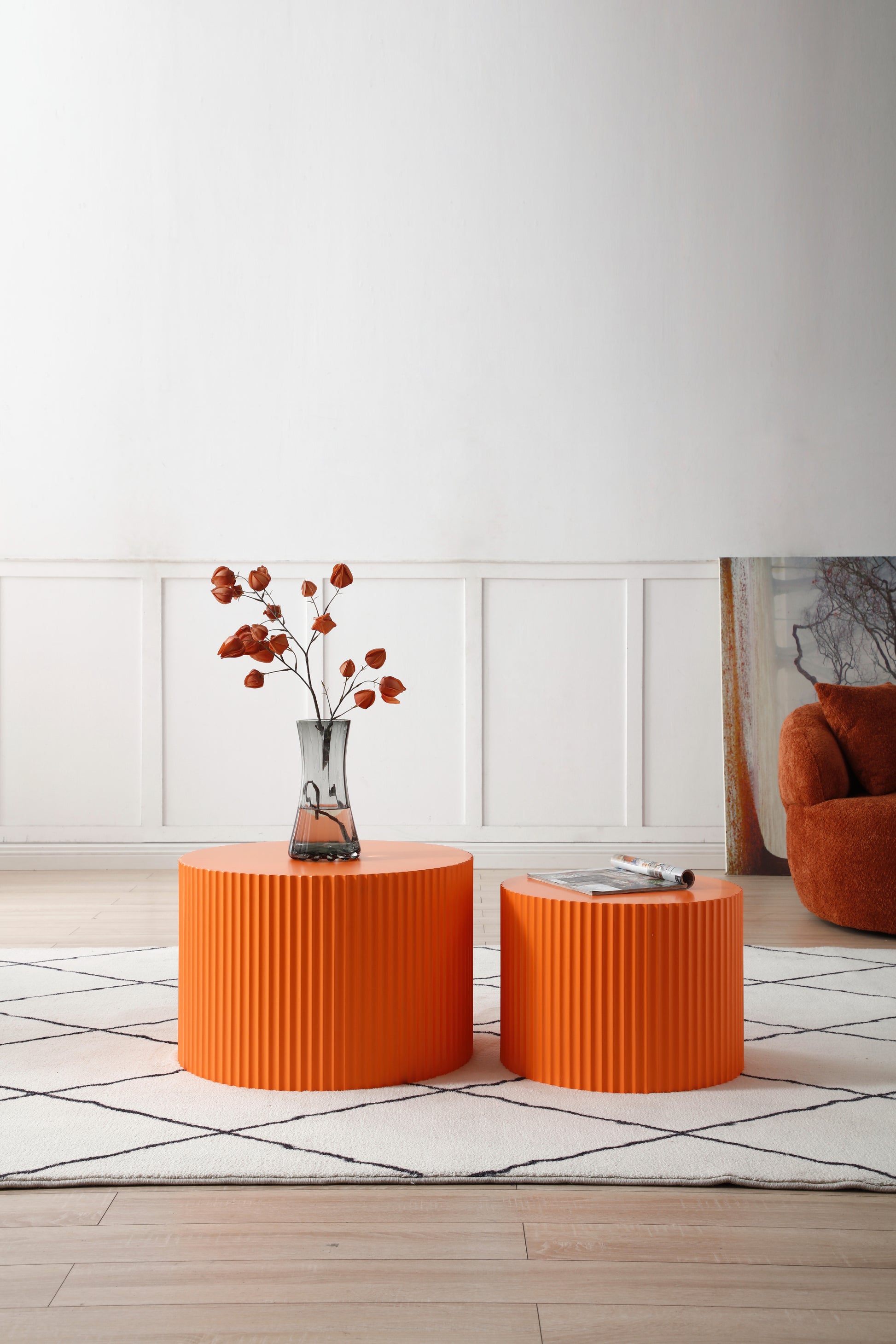 an orange table with a vase of flowers on top of it