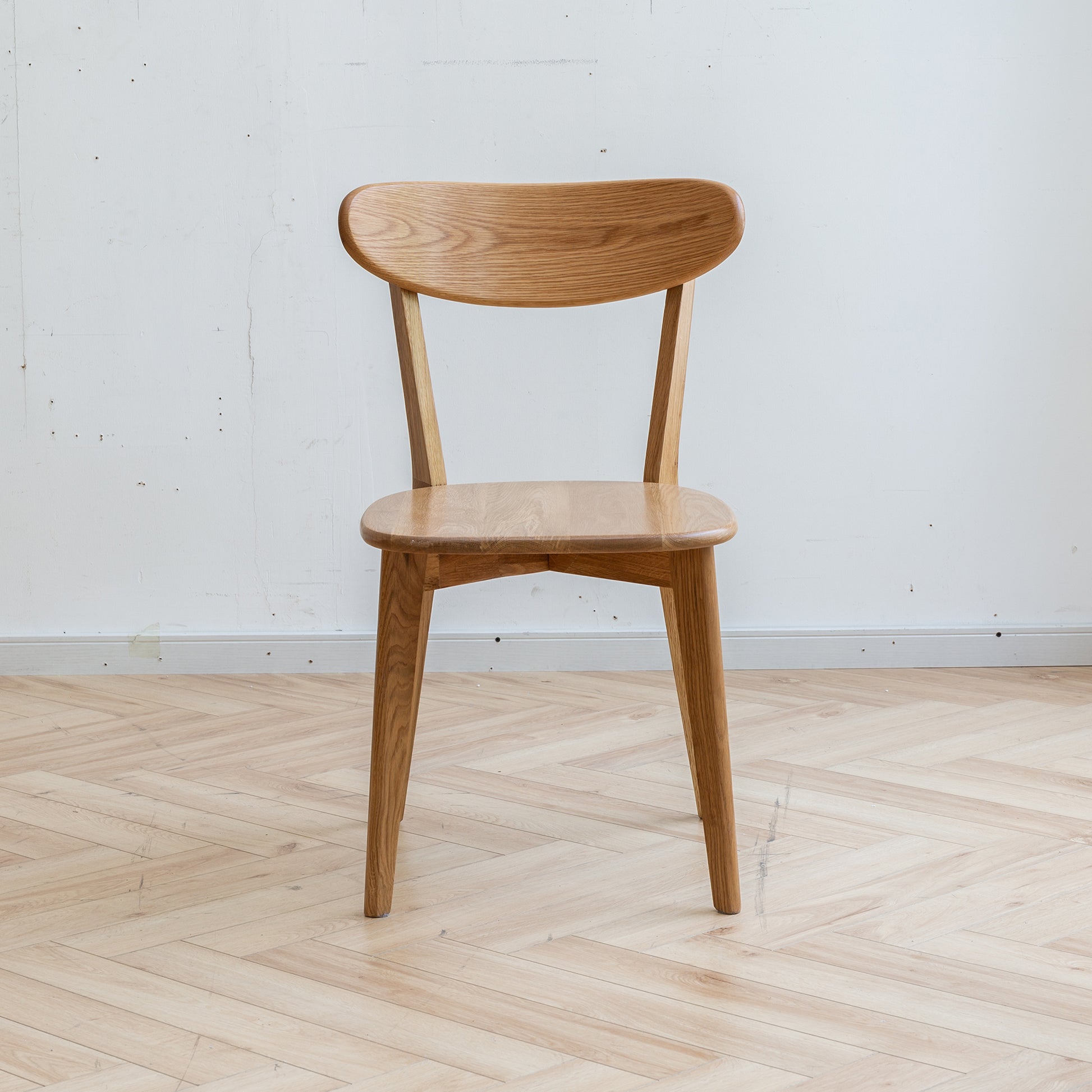 a wooden chair sitting on top of a hard wood floor