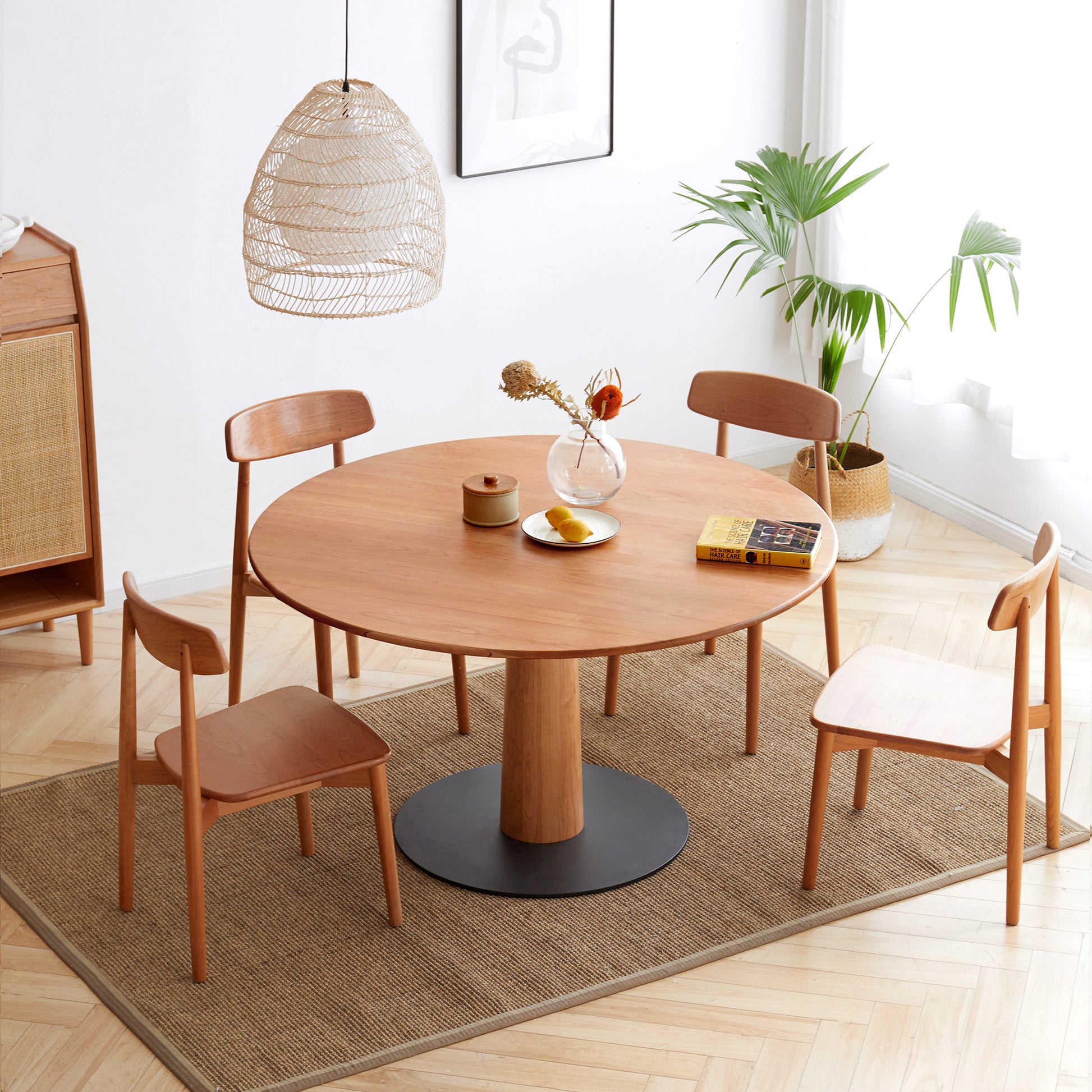 a round wooden table with four chairs around it