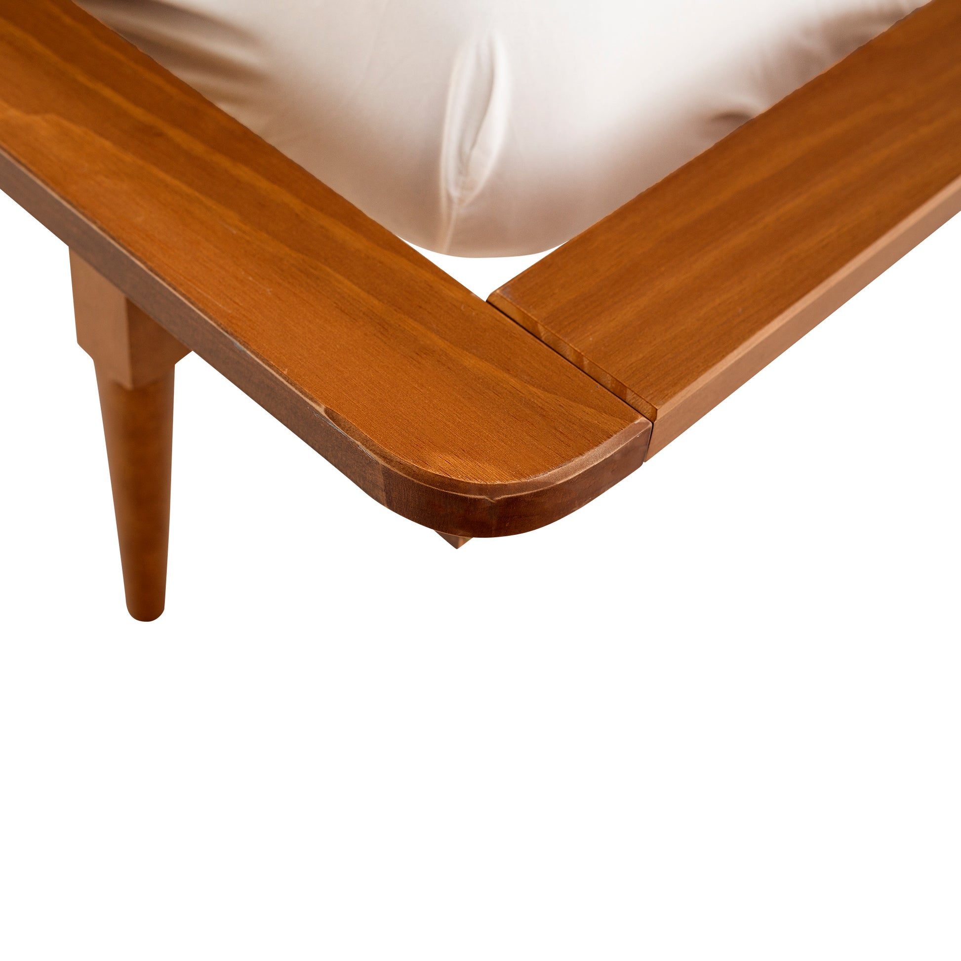 a close up of a bed with a wooden frame