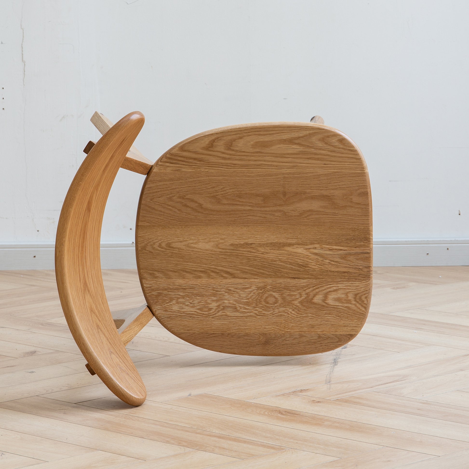 a wooden chair sitting on top of a hard wood floor