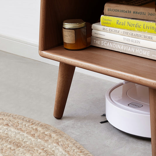 Pure Solid Wood Bedside Cabinet with open compartments seen in a modern bedroom setting, showcasing its compact round shape and safety edging design.