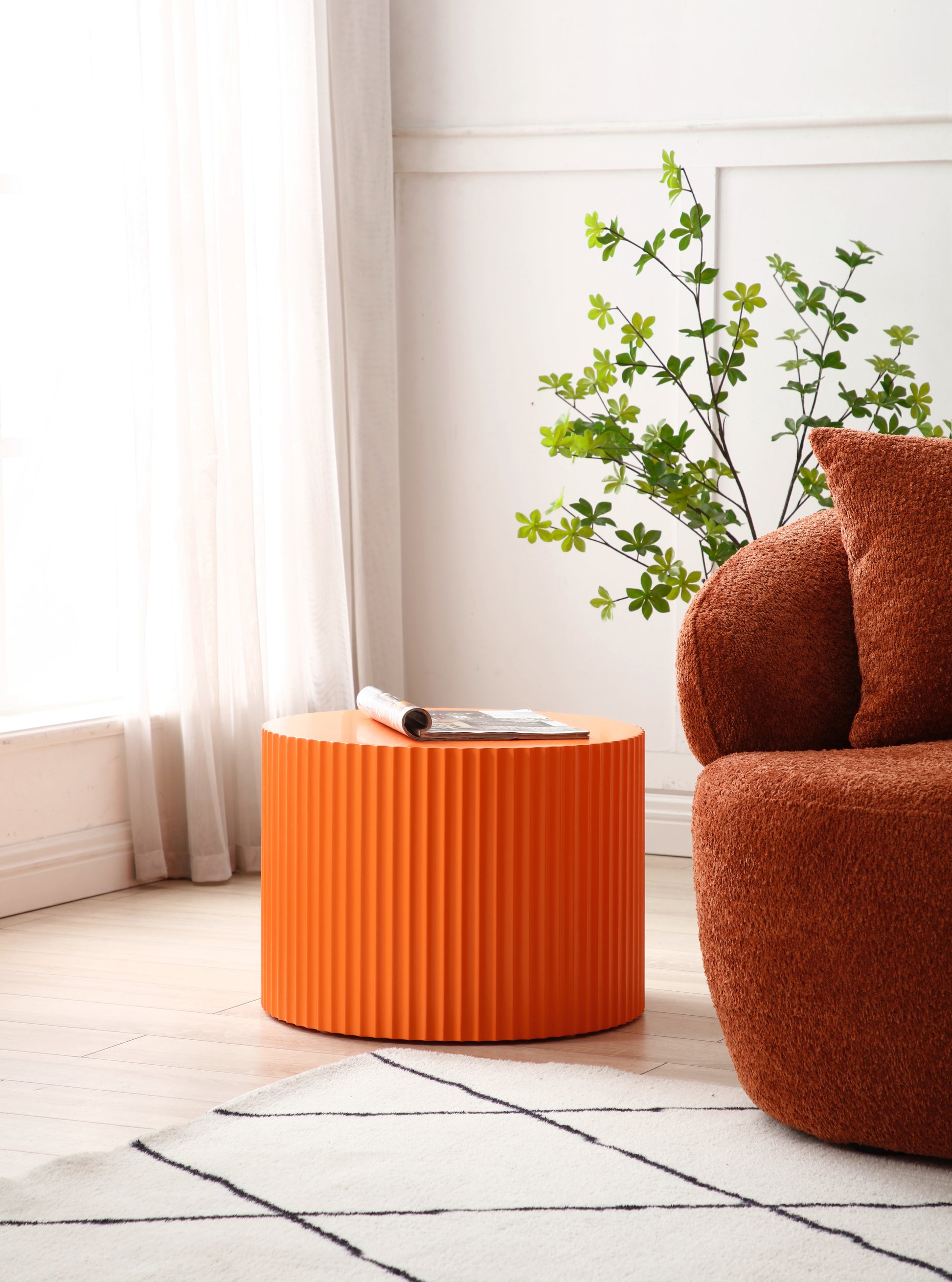 a living room with a chair and a plant