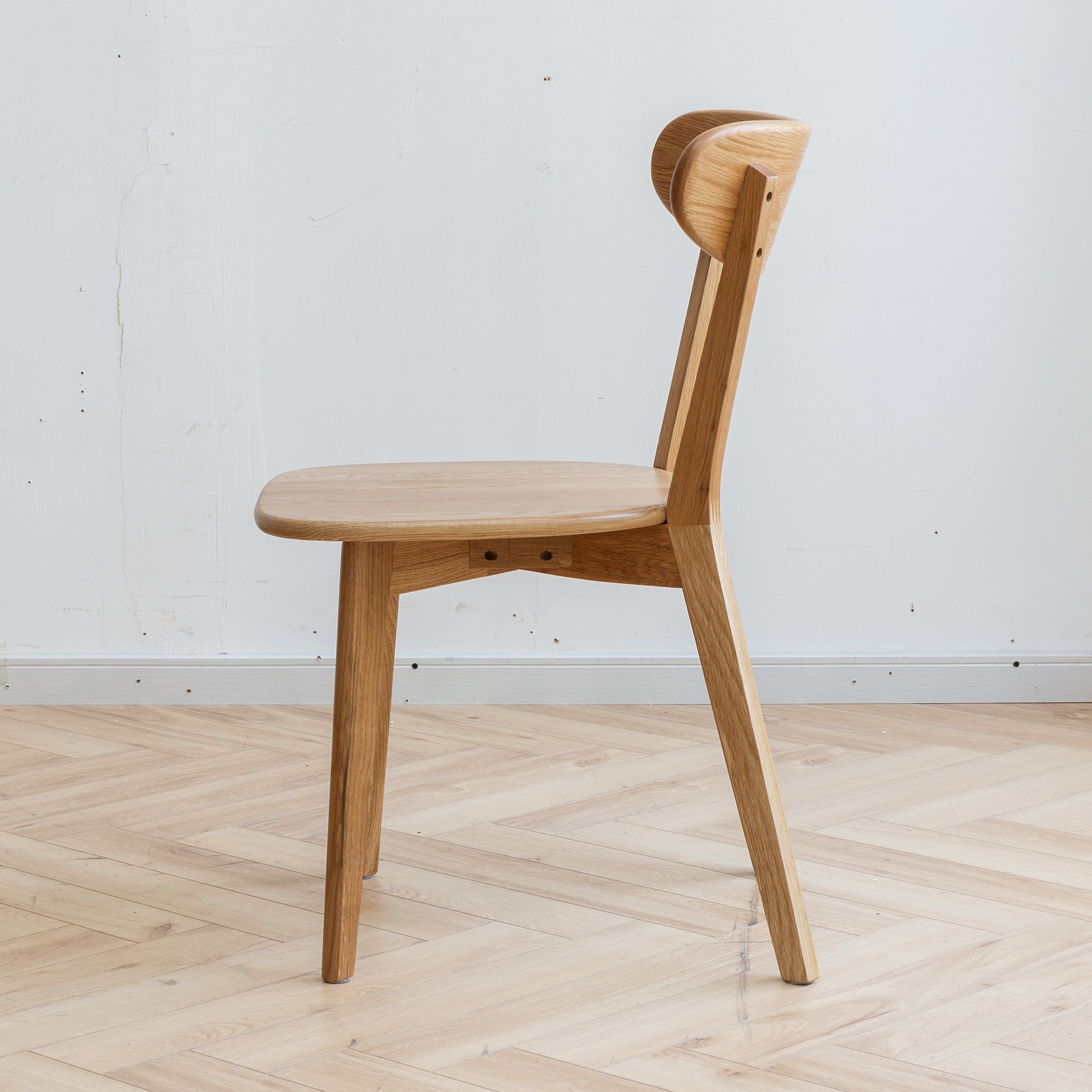 a wooden chair sitting on top of a hard wood floor