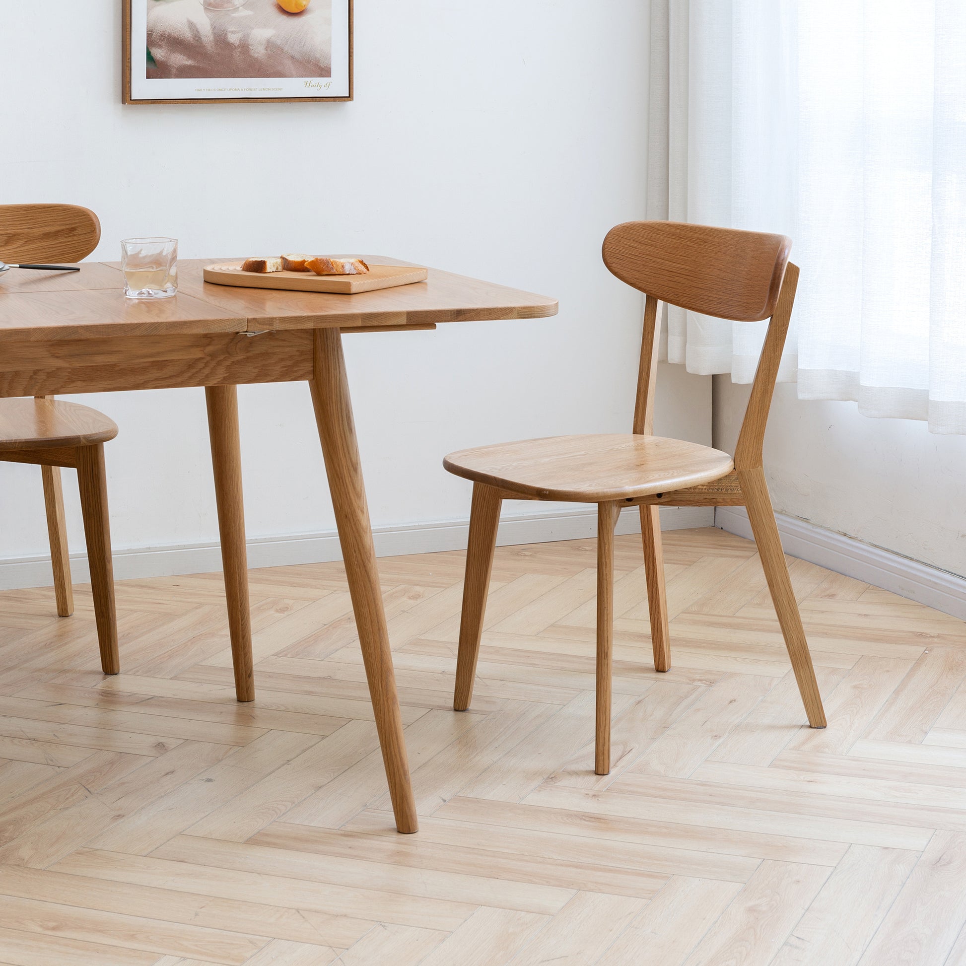 a wooden table and two chairs in a room