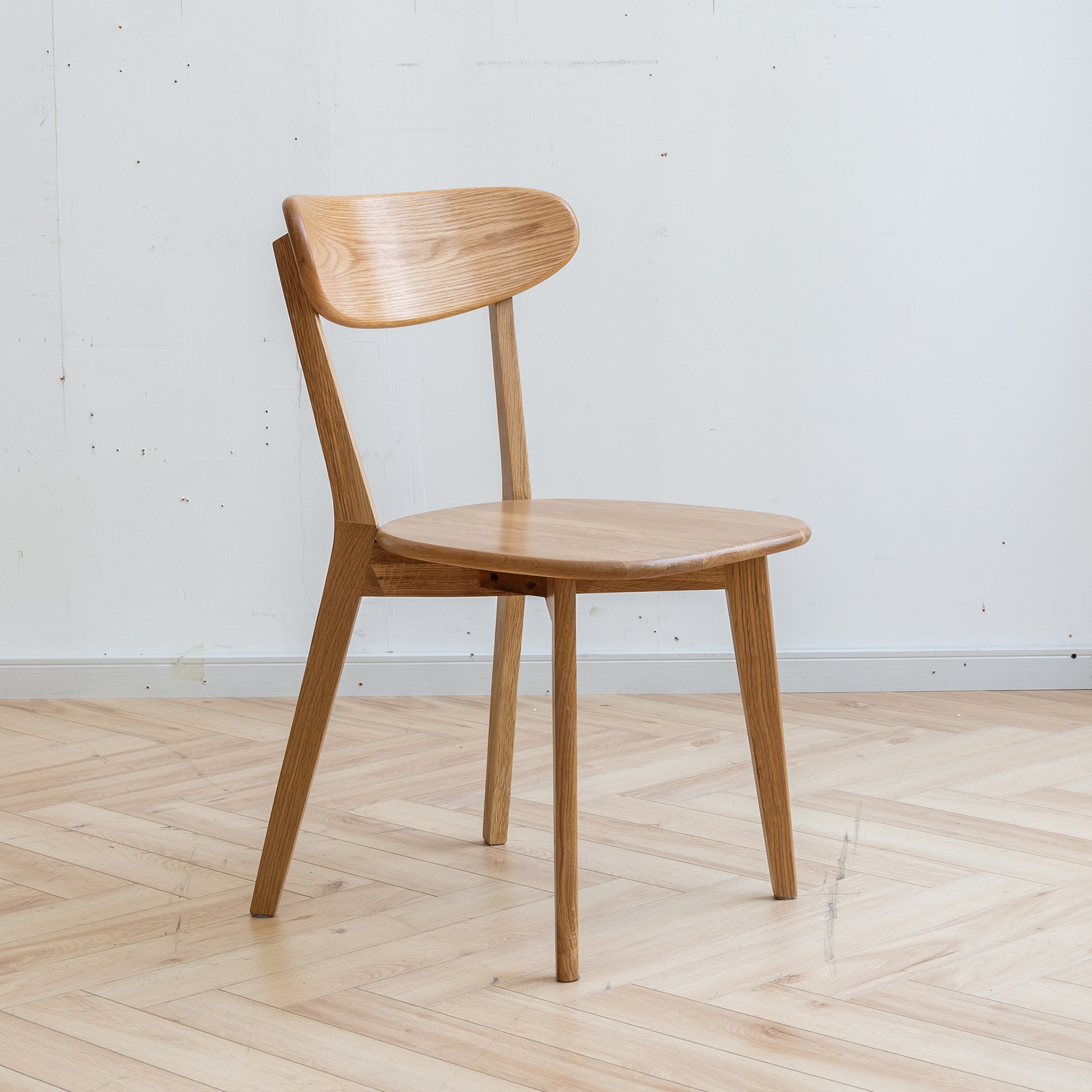 a wooden chair sitting on top of a hard wood floor