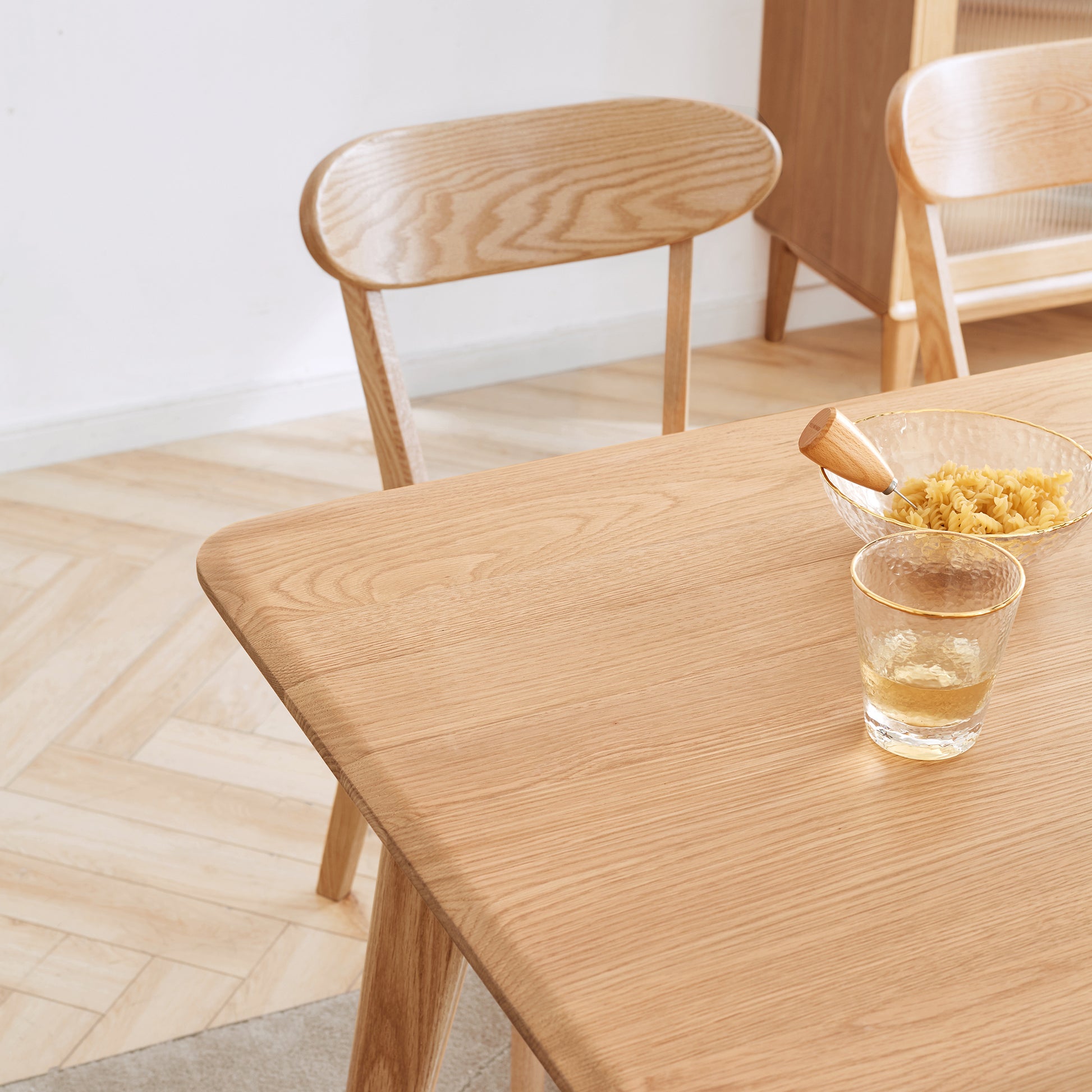 a wooden table topped with a glass filled with liquid