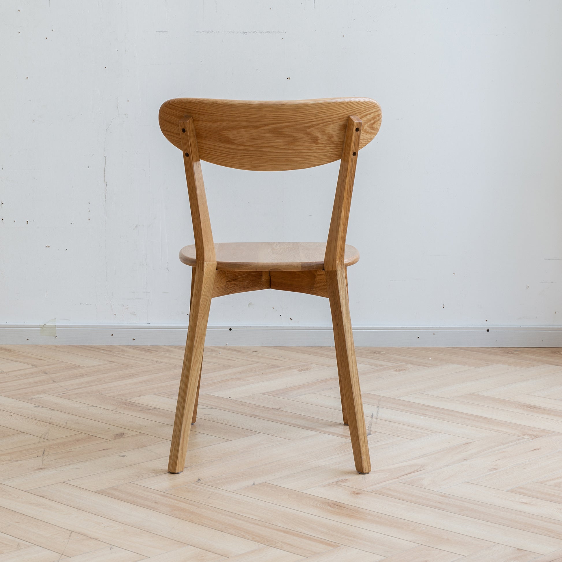 a wooden chair sitting on top of a hard wood floor