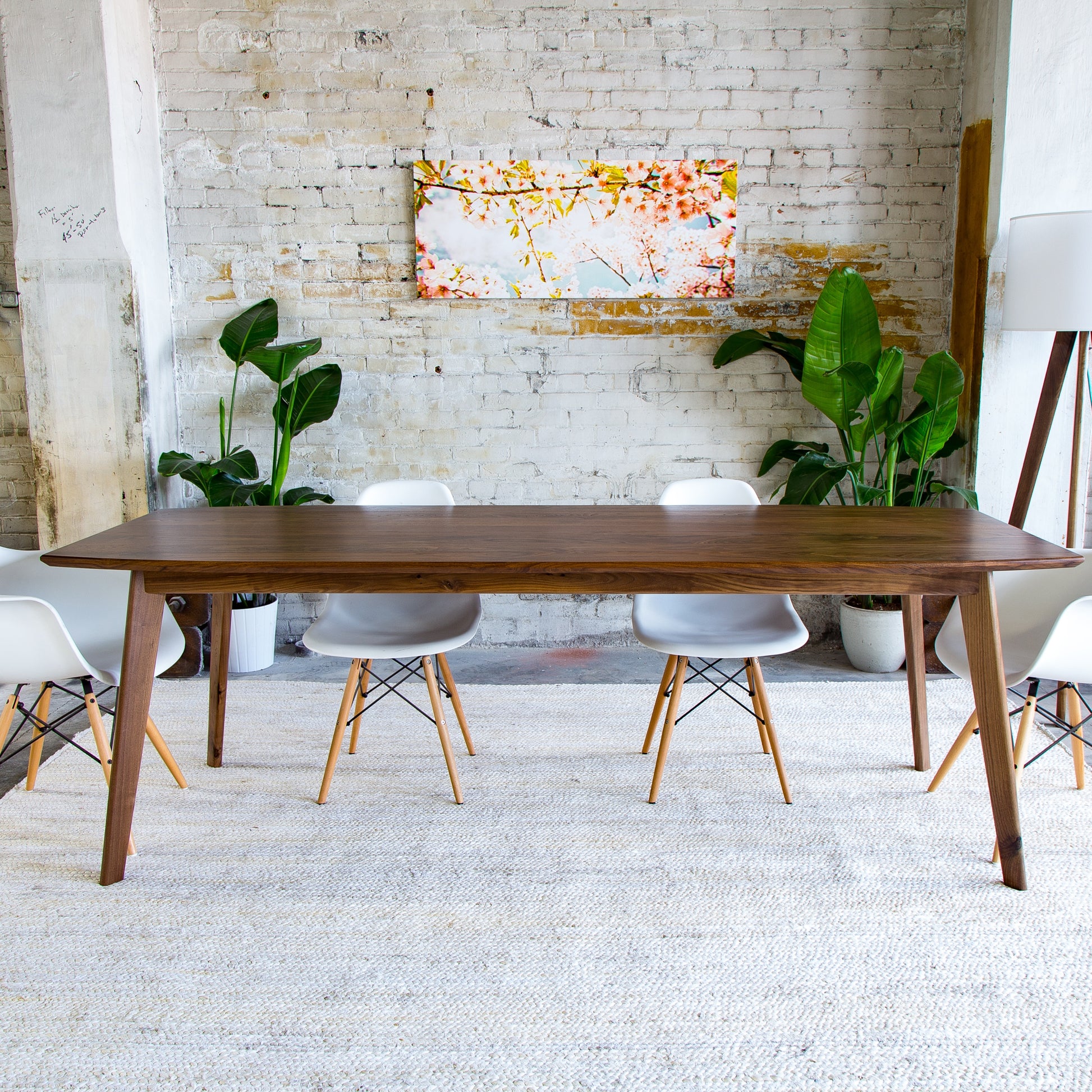 This artisanal walnut dining table boasts mid-century modern elegance, perfect for eco-friendly home decor.