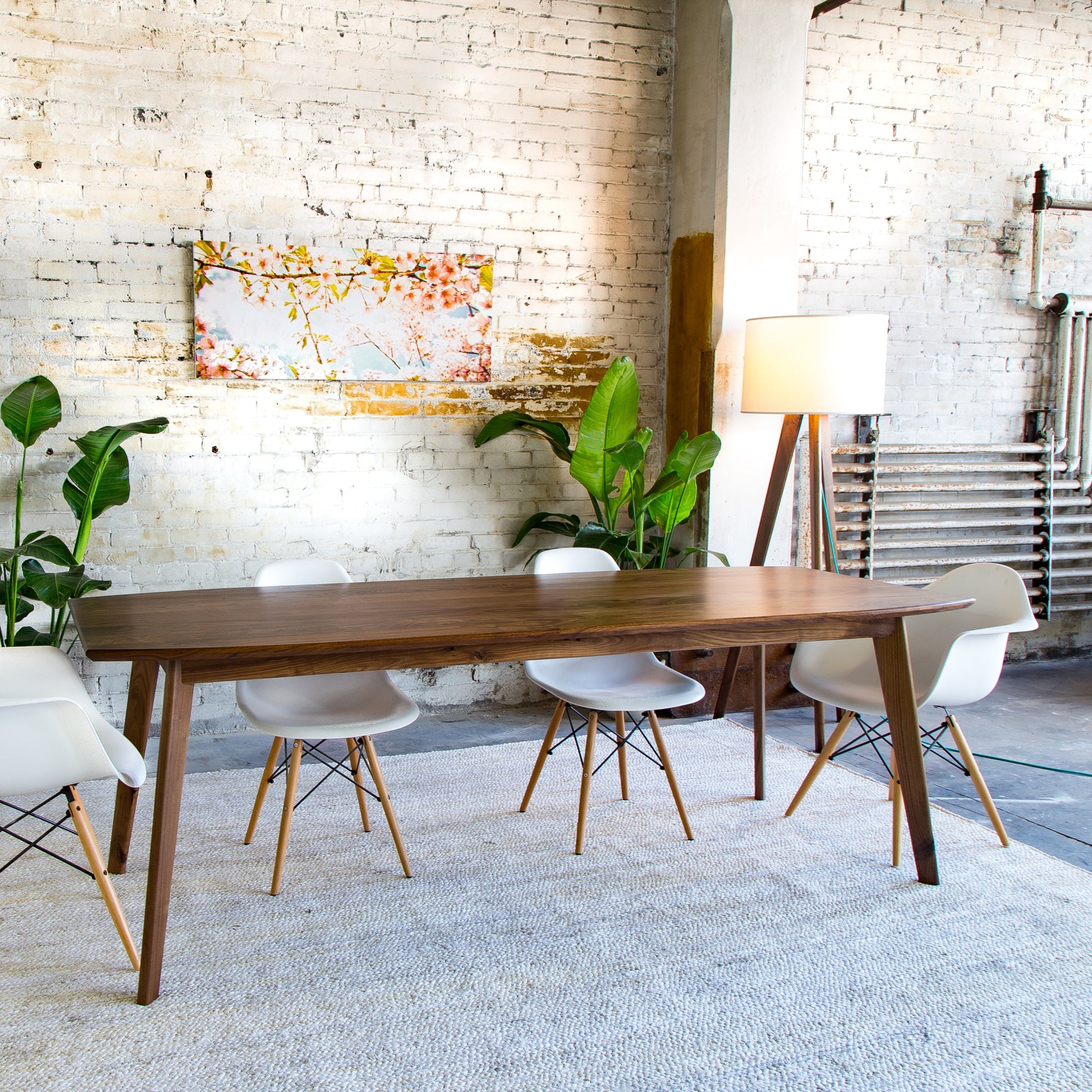 Experience the perfect fusion of style and sustainability with our Santa Monica dining table. (Pictured: A mid-century modern walnut table, showcasing expert craftsmanship and elegant design.)
