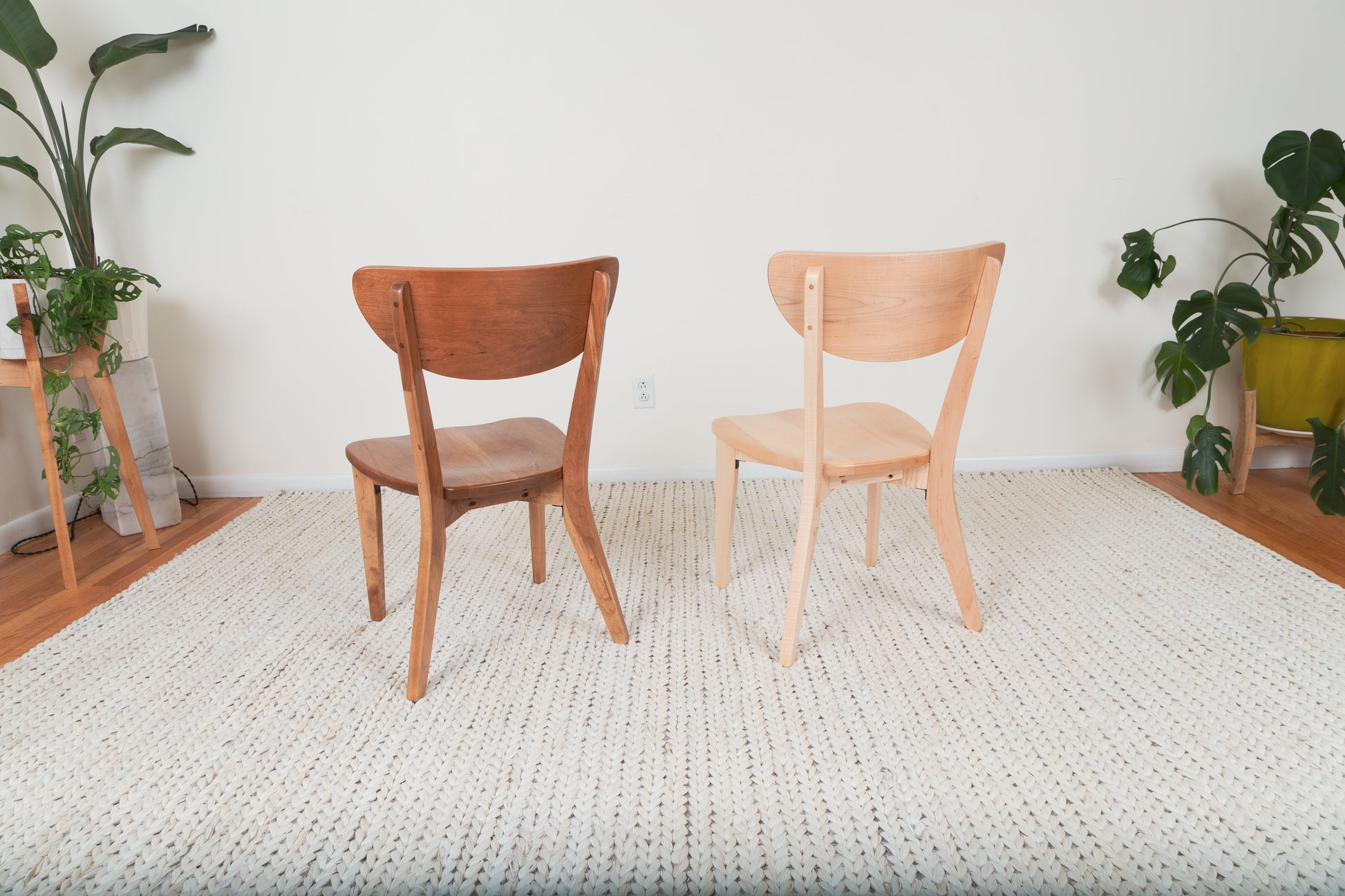 The Seymour - Modern Dining Chair on a white woven rug, showcasing its sleek, handcrafted wooden design, ideal for contemporary dining spaces.