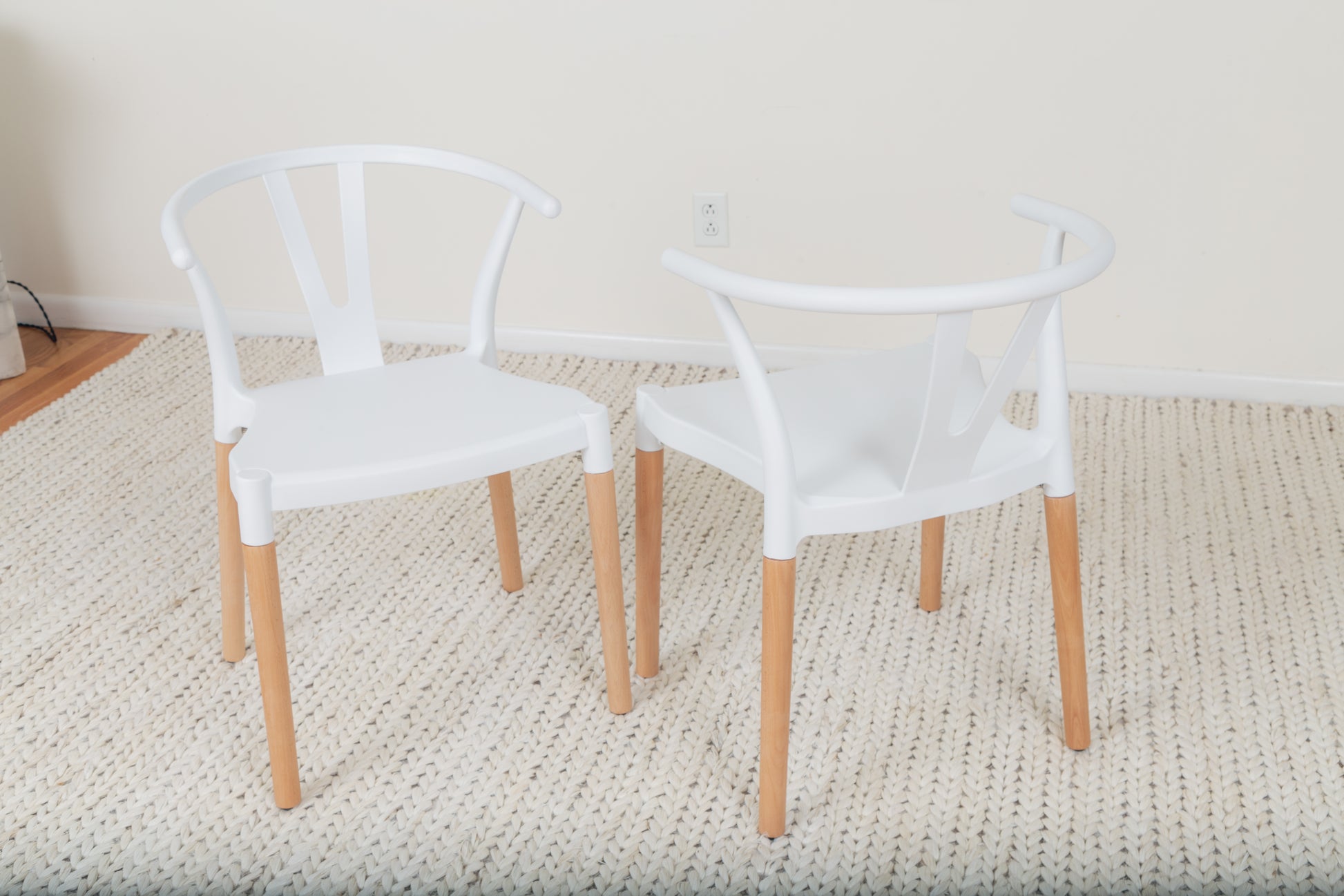 a pair of white chairs sitting next to each other