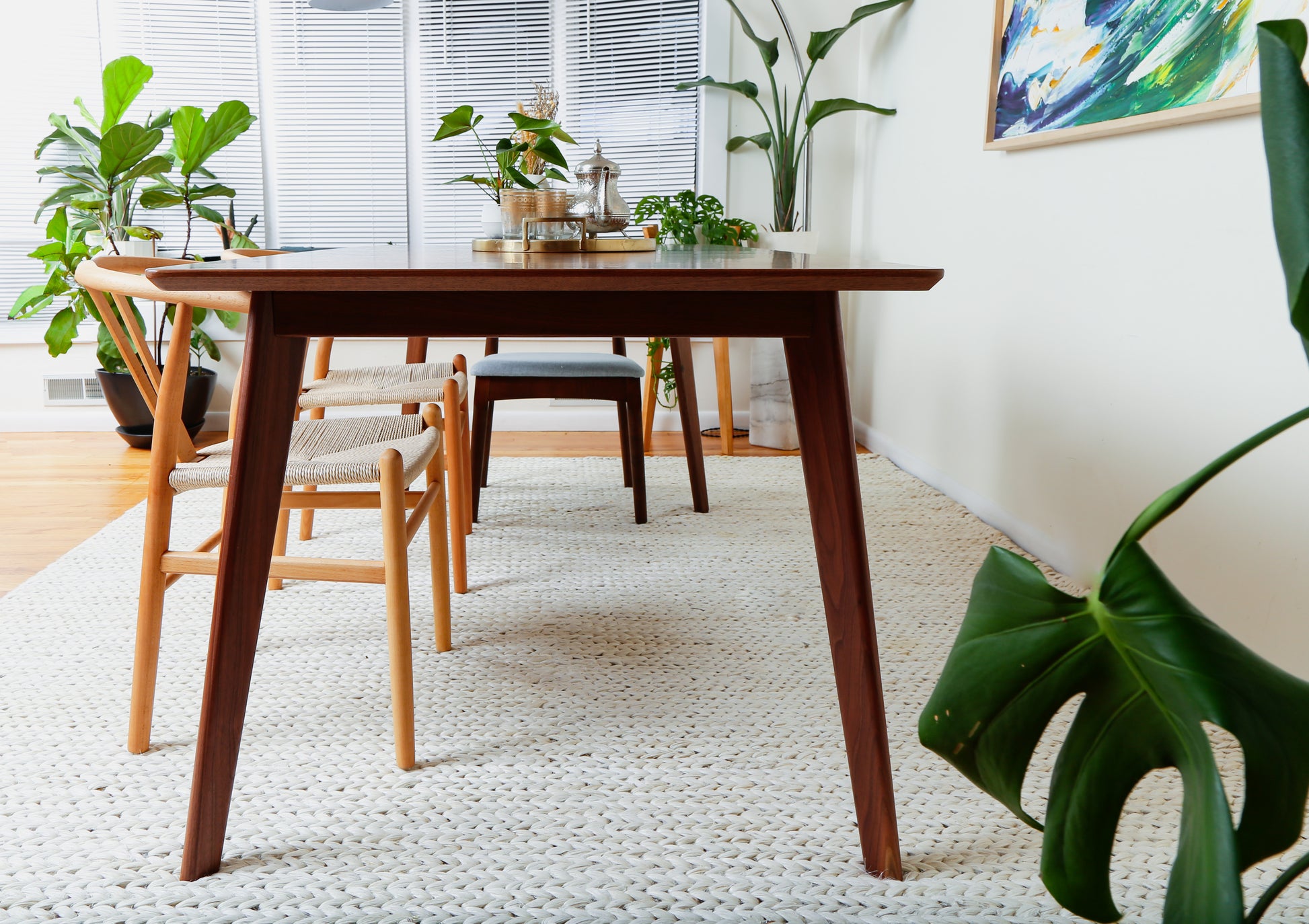 a wooden table with chairs around it in a room