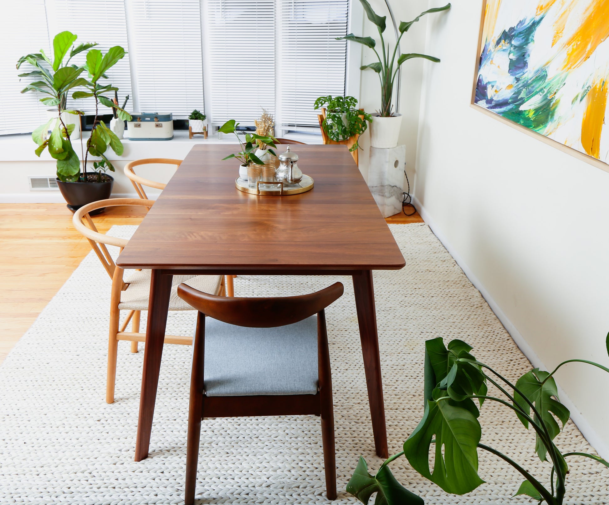 a dining room table with a plant on top of it