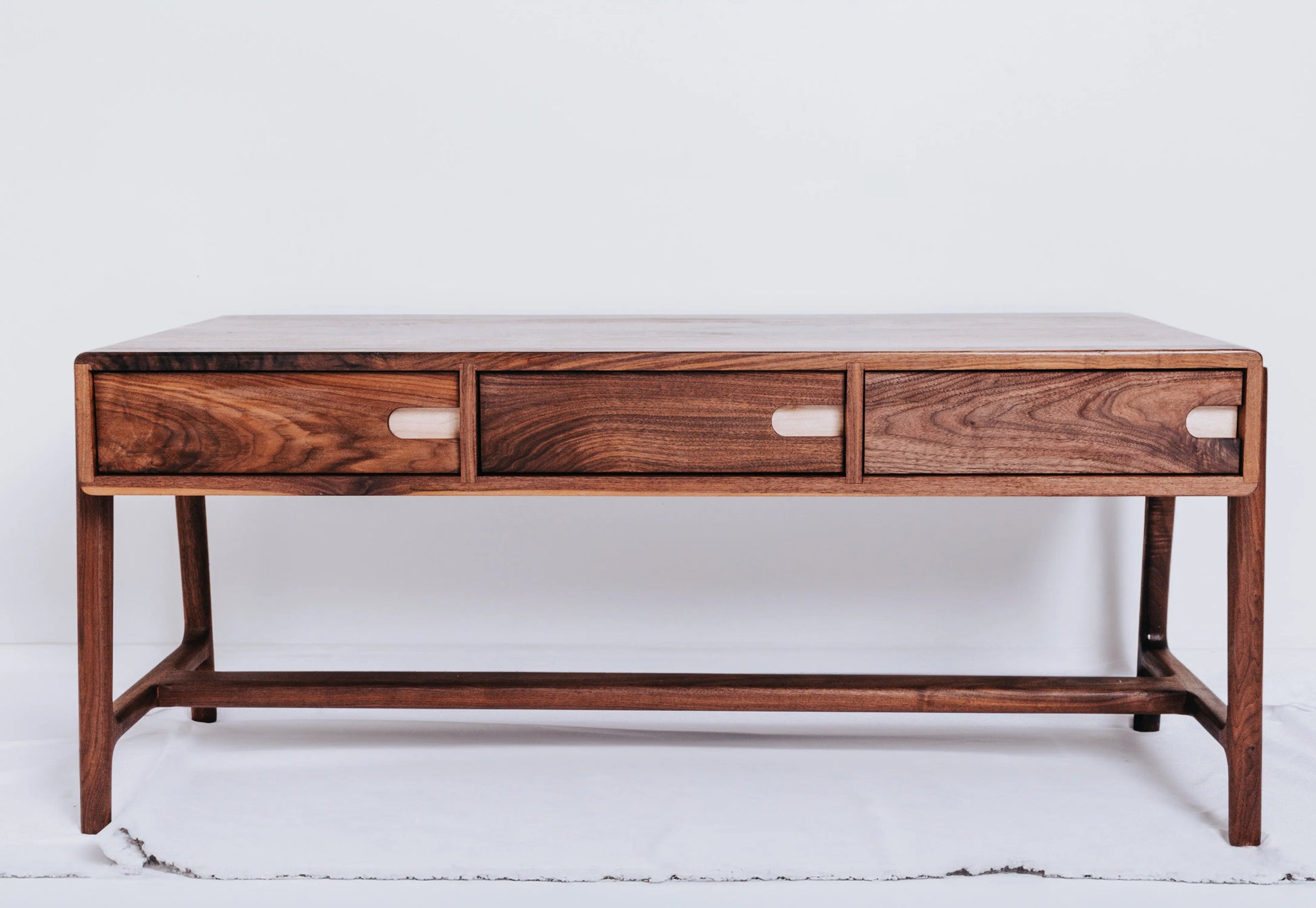 Scandinavian coffee table named Fjord crafted from black walnut with rock maple drawer pulls