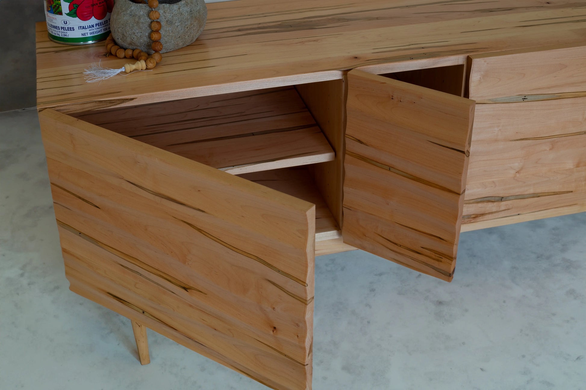 Open Miriam wavy credenza showing handcrafted spalted maple wood with unique grain patterns and bookmatched wavy panels.