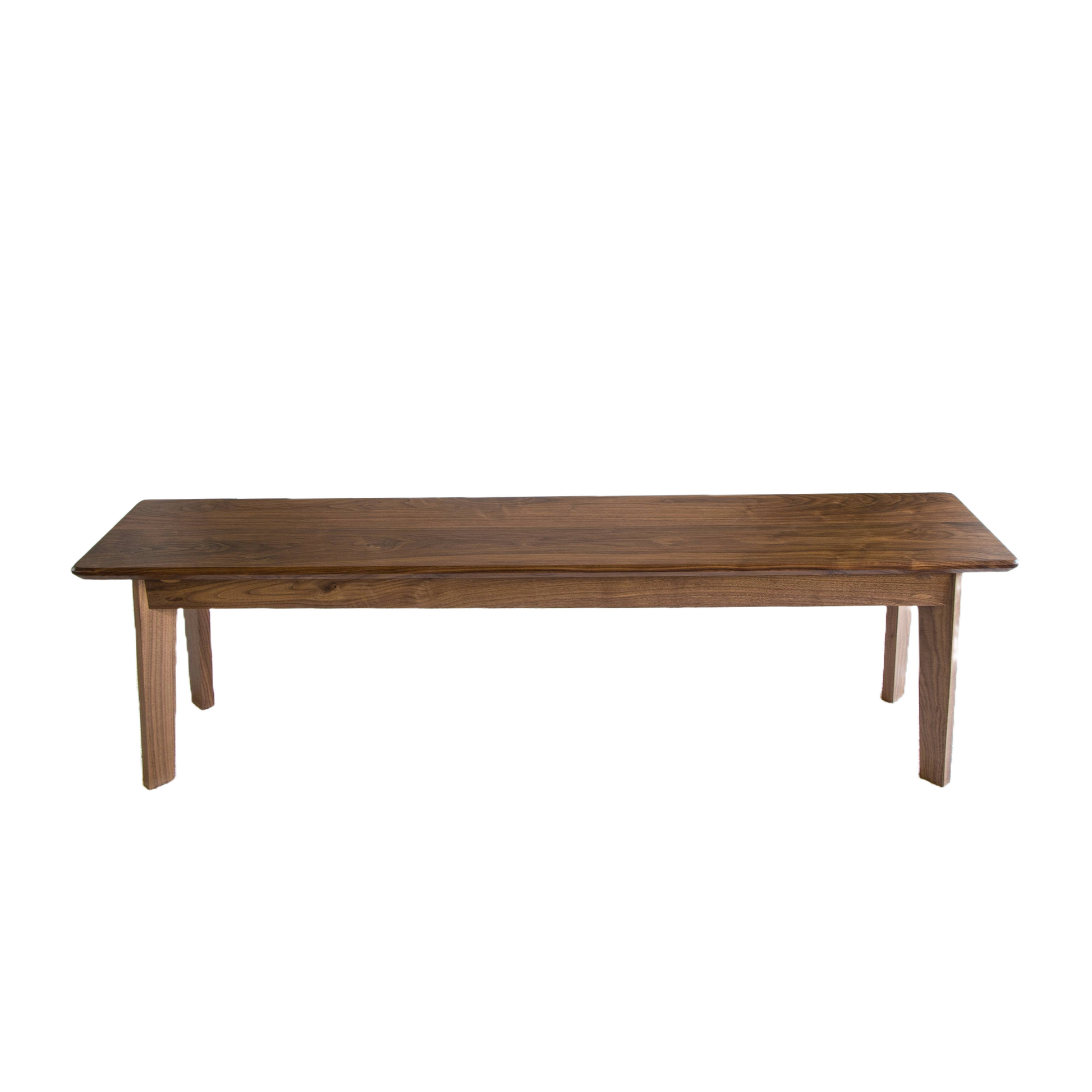 a wooden table sitting on top of a white wall