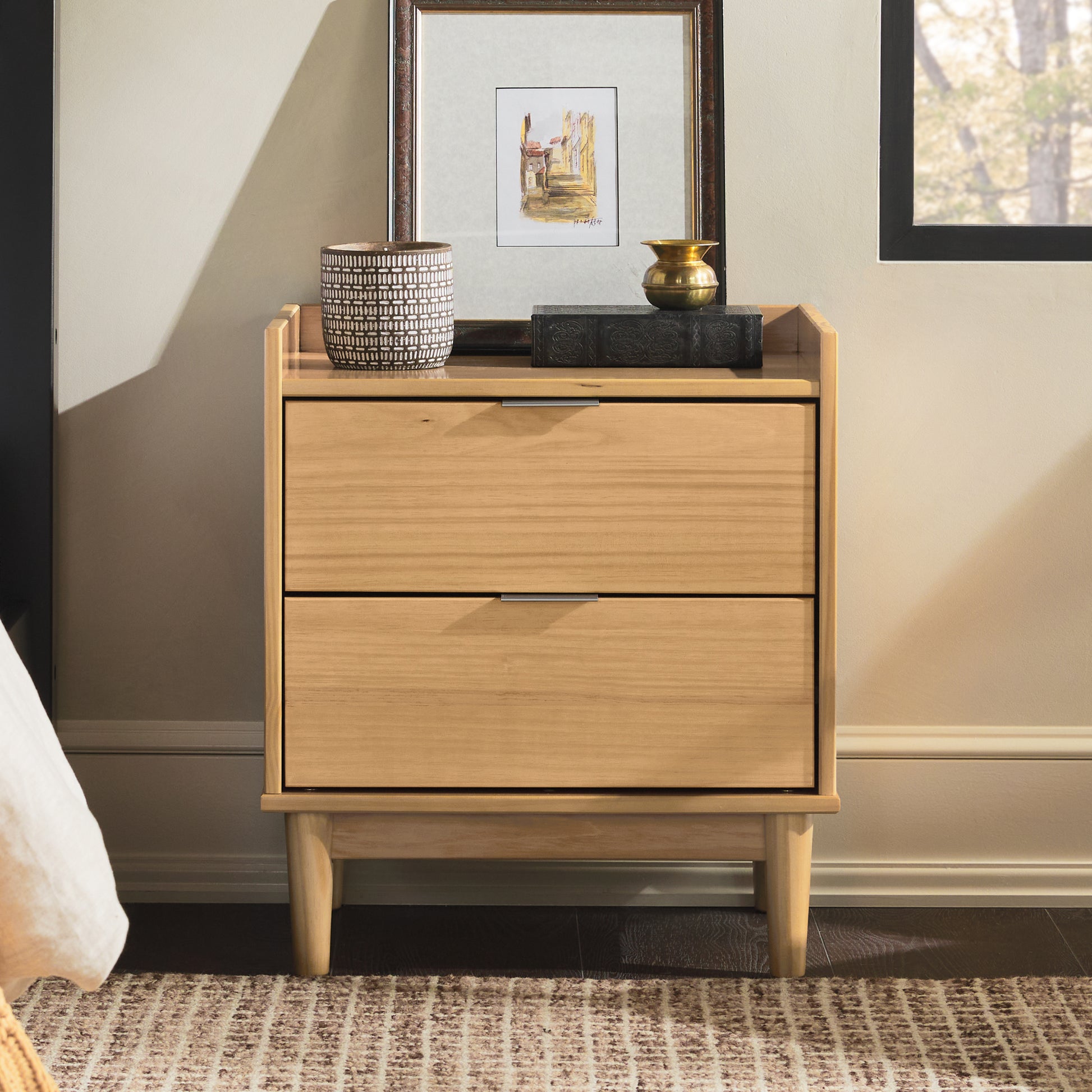 a wooden dresser with a picture on top of it