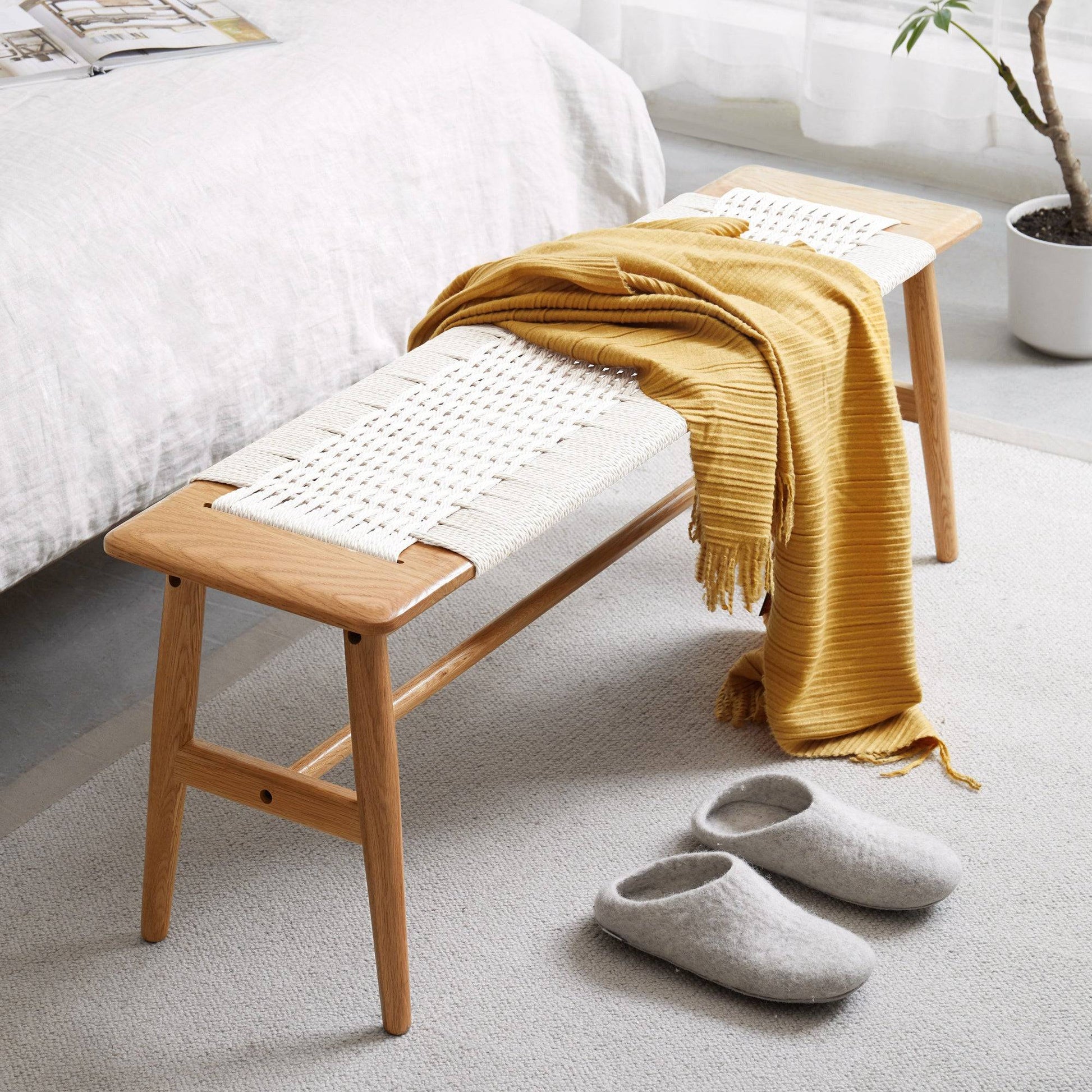 a wooden bench sitting on top of a white rug