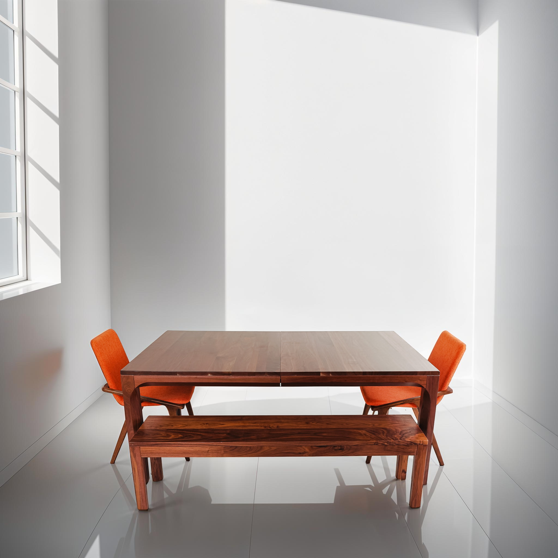 Amish-made walnut dining table with vibrant orange accent chairs
