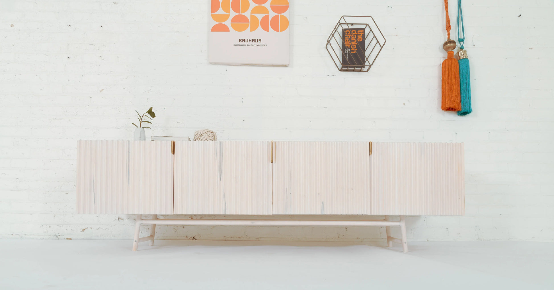 wide angle studio shot of Modern White Sideboard with scandi style decor and white background