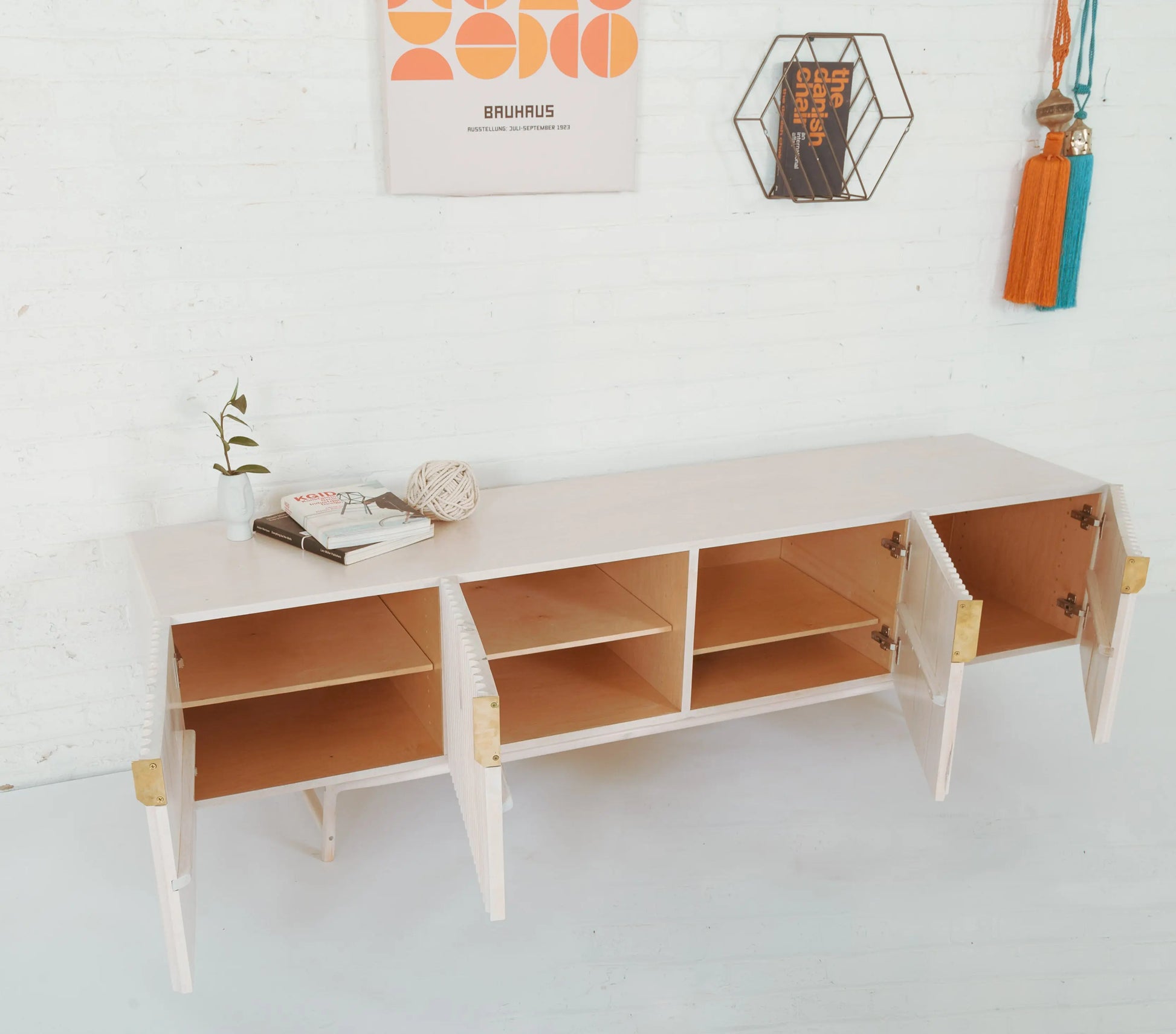 Modern Sideboard, white finish. Four doors. All are open and two have shelves.