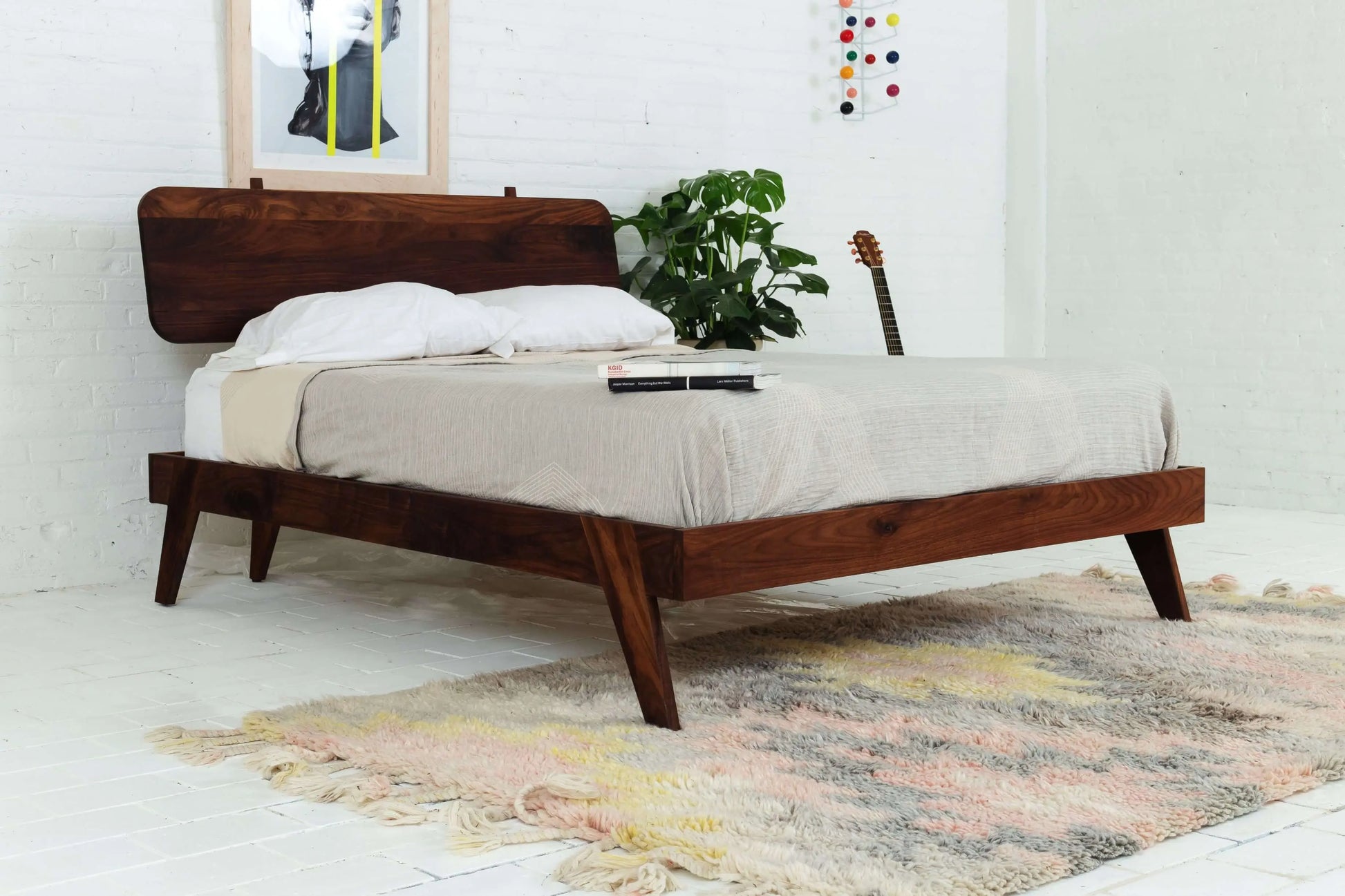 "Modern walnut bed frame with sleek design"