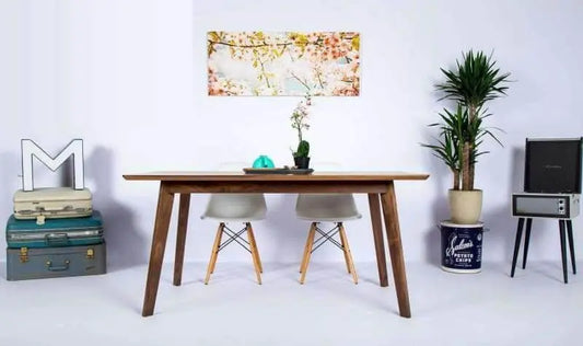 Small Bossa Nova dining table showcasing its 1" thick solid walnut tabletop